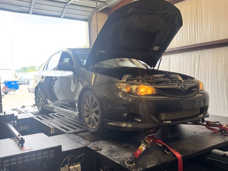 Subaru WRX hatchback on the Apex AWD Dynojet with the hood up