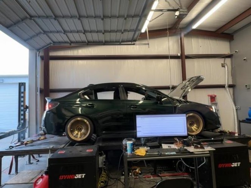 Subaru WRX strapped to the Apex AWD Dynojet with the Dynojet control stations beside it